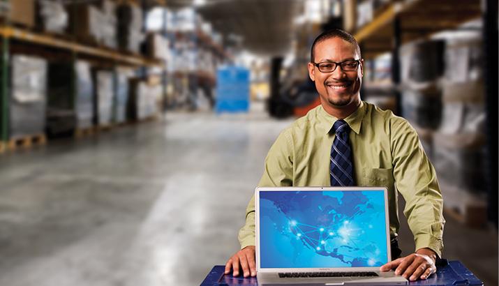 Man in warehouse with a computer