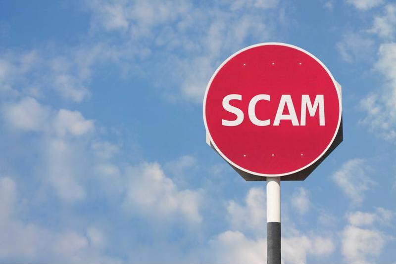 A concept image of a road sign with "scam" written on it.