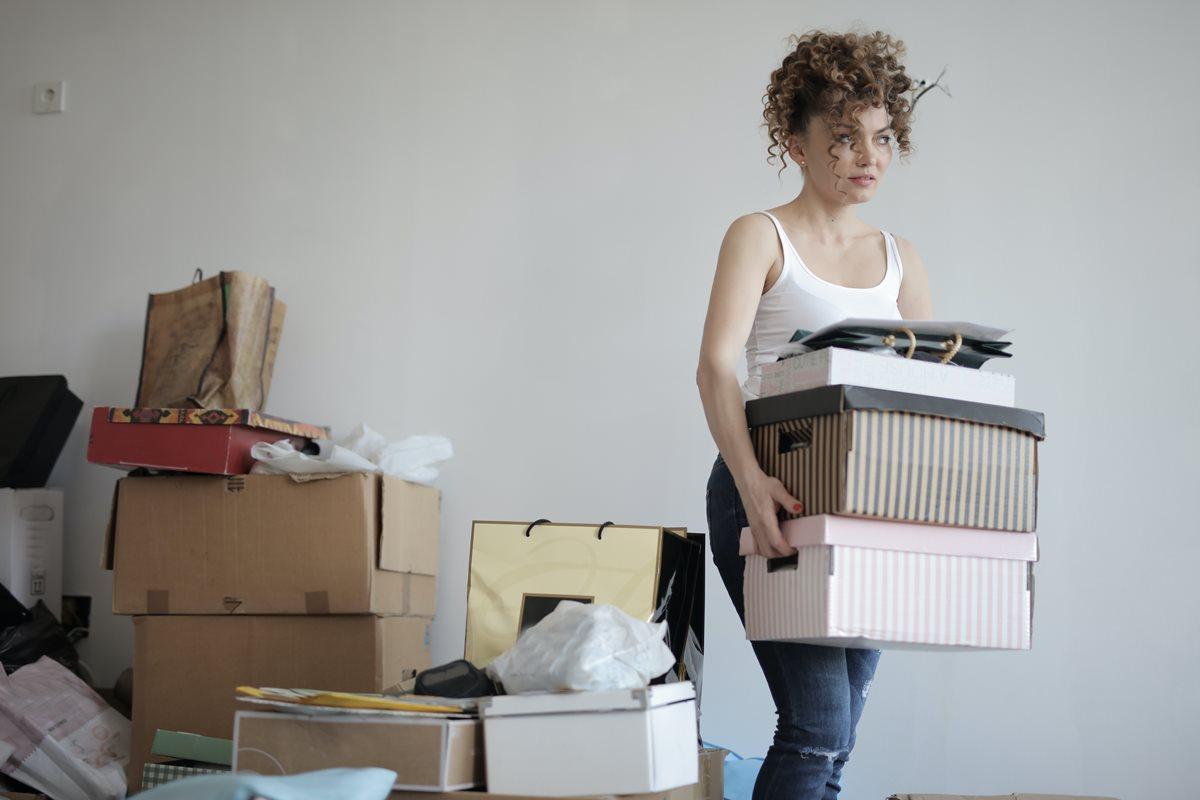 young woman sorting through her belongings to declutter her home before a move