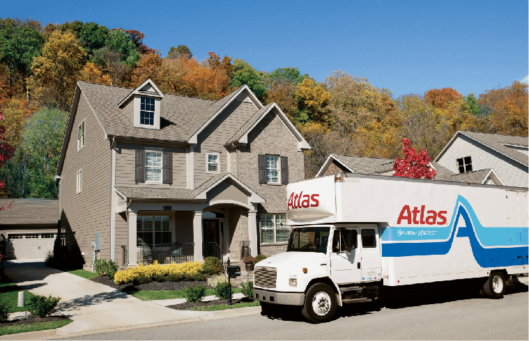 Atlas moving truck parked outside a suburb home