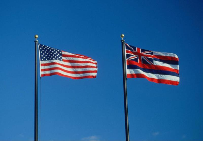 The U.S. flag and Hawaiian state flag, flying side by side.